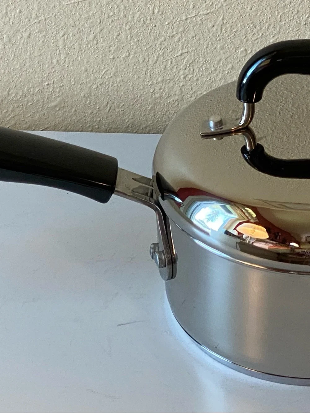 Stainless Steel Saucepan with Black Handle and Lid